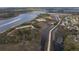 Expansive aerial view highlighting the waterway, marshlands, community, and a passing boat at 545 Two Mile Run, Johns Island, SC 29455