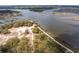 Breathtaking aerial view of wooded coastal land with a sandy trail leading to a private dock with stunning water views at 545 Two Mile Run, Johns Island, SC 29455