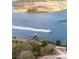 Picturesque aerial view with a boat speeding by a private dock in a tranquil waterfront setting at 545 Two Mile Run, Johns Island, SC 29455