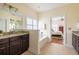 Bright bathroom features a granite countertop, dark wood cabinets and a soaking tub near the bedroom at 545 Two Mile Run, Johns Island, SC 29455