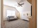 Bright bedroom features a grey sofa, white dresser and wood floors beneath a colorful rug at 545 Two Mile Run, Johns Island, SC 29455