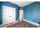 Blue bedroom with wood floors features a closet and stairs leading to the next floor at 545 Two Mile Run, Johns Island, SC 29455