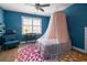 Bright blue bedroom features a canopy bed, desk near the window and wood floors at 545 Two Mile Run, Johns Island, SC 29455
