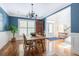 Dining room adjacent to foyer features table and chairs, natural light, and blue accent wall at 545 Two Mile Run, Johns Island, SC 29455