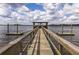 Scenic view of a wooden dock extending over the water, offering access and tranquil waterfront enjoyment at 545 Two Mile Run, Johns Island, SC 29455