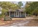 Charming exterior screened-in porch and picnic bench surrounded by a lush, wooded landscape offering a serene outdoor retreat at 545 Two Mile Run, Johns Island, SC 29455