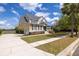 Beautiful two-story home with a long driveway, manicured lawn and mature trees adding curb appeal at 545 Two Mile Run, Johns Island, SC 29455