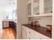 Bright kitchen featuring ample storage with custom cabinets and a wood countertop at 545 Two Mile Run, Johns Island, SC 29455