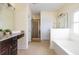 Bright main bathroom features a soaking tub, walk-in shower, and vanity with granite counters at 545 Two Mile Run, Johns Island, SC 29455