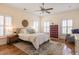 Bright main bedroom featuring hardwood floors, neutral walls, a ceiling fan, and plantation shutters at 545 Two Mile Run, Johns Island, SC 29455