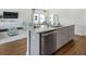 Open-concept kitchen with a large island, stainless steel appliances, and a view of the living area at 584 Red Monarch Way, Moncks Corner, SC 29461