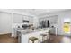 Bright kitchen with stainless steel appliances, gray countertops, and ample cabinet space at 584 Red Monarch Way, Moncks Corner, SC 29461