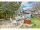 Cozy brick patio with outdoor seating and a fire pit, nestled under the shade of a mature tree, perfect for entertaining at 633 Schooner Rd, Charleston, SC 29412