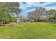 Large backyard with mature tree and green lawn offers space for relaxing or entertaining at 633 Schooner Rd, Charleston, SC 29412