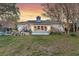 Rear view of home featuring a brick exterior, covered porch, and landscaped yard at 633 Schooner Rd, Charleston, SC 29412
