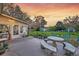 Backyard at sunset with a patio, outdoor seating, garden and a large grassy area at 633 Schooner Rd, Charleston, SC 29412