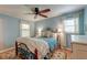 Cozy bedroom featuring blue walls, ceiling fan, and an ornate metal bed frame at 633 Schooner Rd, Charleston, SC 29412