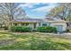 Well-maintained home with brick exterior, a landscaped yard, and attached garage at 633 Schooner Rd, Charleston, SC 29412