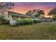 Charming single-story home with brick accents, a covered porch, and lush landscaping at 633 Schooner Rd, Charleston, SC 29412