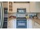 Modern kitchen featuring updated appliances, granite countertops, tiled backsplash, and cabinetry at 633 Schooner Rd, Charleston, SC 29412