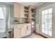 A well-lit kitchenette features a stainless steel fridge, microwave, and window with natural light at 633 Schooner Rd, Charleston, SC 29412