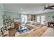 Cozy living room featuring comfortable seating, a TV, and a small kitchenette with access to the yard at 633 Schooner Rd, Charleston, SC 29412