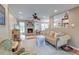 Comfortable living room with a fireplace, ceiling fan, and neutral decor, perfect for relaxation and entertaining guests at 633 Schooner Rd, Charleston, SC 29412