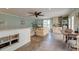An open living space features a ceiling fan, TV, sitting area, and a kitchenette with light cabinets and modern appliances at 633 Schooner Rd, Charleston, SC 29412