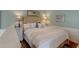 Cozy bedroom with unique headboard, lamps and framed prints at 633 Schooner Rd, Charleston, SC 29412