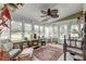 Cozy sunroom with multiple windows offering bright natural light and vintage furniture at 633 Schooner Rd, Charleston, SC 29412