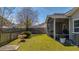Landscaped backyard featuring a bench, patio, and privacy fence at 8208 Little Sydneys Way, North Charleston, SC 29406