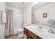 Bright bathroom featuring a shower-tub combo, white vanity with sink, and neutral decor at 8208 Little Sydneys Way, North Charleston, SC 29406