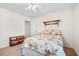 Bright bedroom featuring a floral patterned quilt, ceiling fan, and double door closet at 8208 Little Sydneys Way, North Charleston, SC 29406