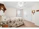 Cozy bedroom featuring a floral patterned quilt, ceiling fan, and double door closet at 8208 Little Sydneys Way, North Charleston, SC 29406