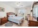 Comfortable bedroom with blue and white bedding, ceiling fan, and lots of natural light at 8208 Little Sydneys Way, North Charleston, SC 29406