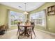 Bright breakfast nook featuring a round wooden table, four chairs and large windows at 8208 Little Sydneys Way, North Charleston, SC 29406