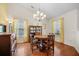 Bright dining room with hardwood floors, stylish lighting and yellow accents at 8208 Little Sydneys Way, North Charleston, SC 29406