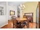 Bright dining room with hardwood floors, stylish lighting and classic furniture at 8208 Little Sydneys Way, North Charleston, SC 29406