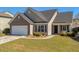 Attractive single-Gathering home boasting a well-kept lawn, a two-car garage, and a welcoming front entrance at 8208 Little Sydneys Way, North Charleston, SC 29406