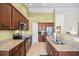Modern kitchen with granite countertops, stainless steel appliances, and dark wood cabinetry at 8208 Little Sydneys Way, North Charleston, SC 29406