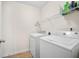 Functional laundry room featuring a washer, dryer, tile flooring, and built in shelf at 8208 Little Sydneys Way, North Charleston, SC 29406