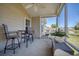 Covered patio with fan, furnishings and a view of the water at 8208 Little Sydneys Way, North Charleston, SC 29406