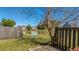 Scenic backyard overlooking a serene pond, bordered by a wooden fence and vibrant landscaping at 8208 Little Sydneys Way, North Charleston, SC 29406