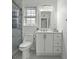 Bathroom featuring a modern vanity, updated fixtures, toilet, and shower with glass door and marble design at 874 Colony Drive # B19, Charleston, SC 29407
