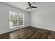 This bedroom features hardwood floors, a ceiling fan, and a large window at 874 Colony Drive # B19, Charleston, SC 29407