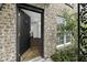 Inviting brick home featuring a glimpse of the hardwood floors through an open entryway at 874 Colony Drive # B19, Charleston, SC 29407