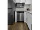 Kitchen with stainless steel appliances, granite countertops, white cabinetry, and wood-look floors at 874 Colony Drive # B19, Charleston, SC 29407