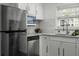 Bright kitchen featuring stainless steel appliances, granite countertops, white cabinets, and modern fixtures at 874 Colony Drive # B19, Charleston, SC 29407