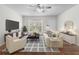 Stylishly staged living room with a ceiling fan and plenty of natural light at 874 Colony Drive # B19, Charleston, SC 29407