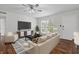 A view of the bright living room, with staged furniture, hardwood floors and modern ceiling fan at 874 Colony Drive # B19, Charleston, SC 29407